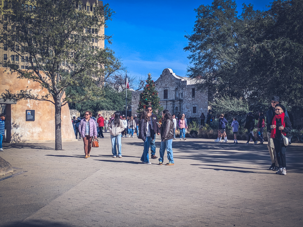 Tourists gather in front of the Alamo in San Antonio, Texas
