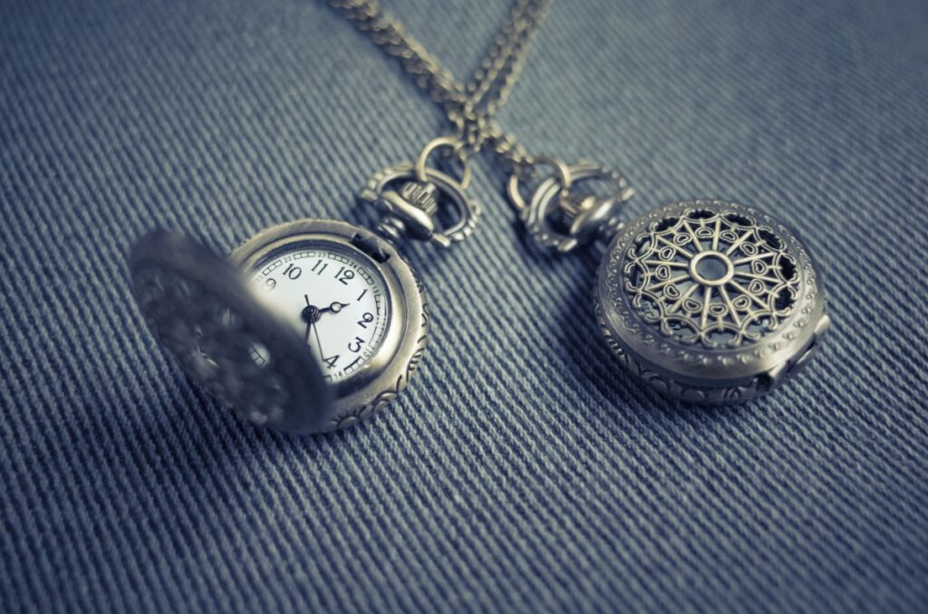 A round pendant necklace with a clock inside