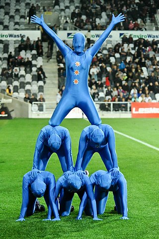 A pyramid of dancers wearing spandex suits