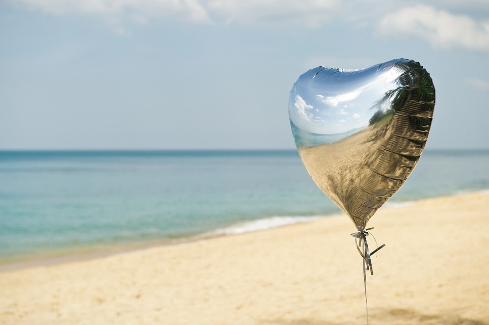 a helium-filled balloon made out of Mylar polyester floating on beach