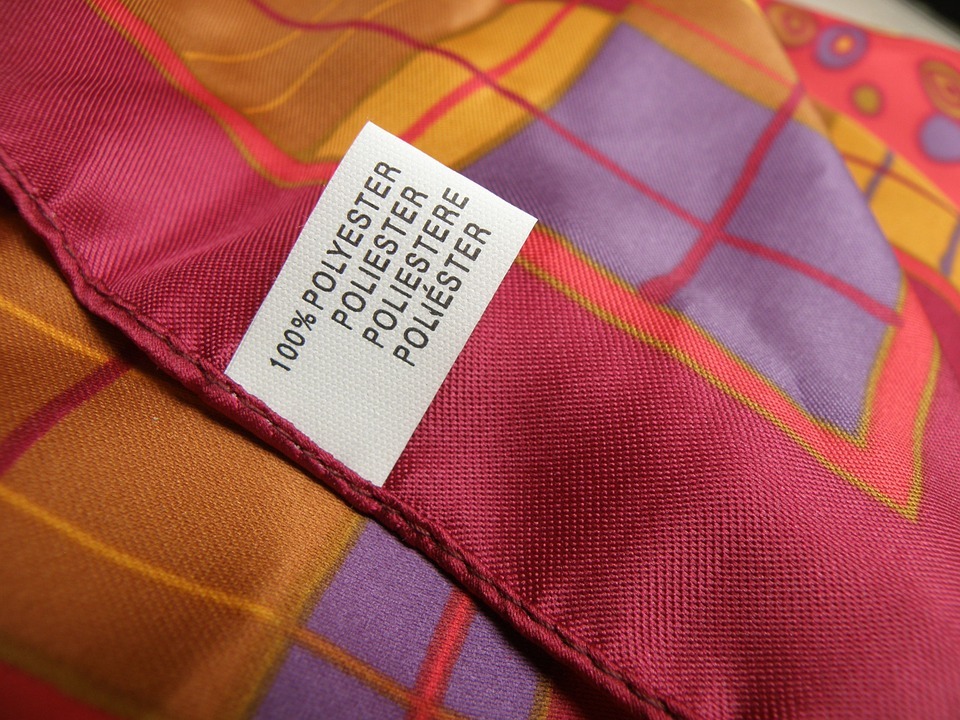 a piece of polyester fabric tagged as 100% polyester