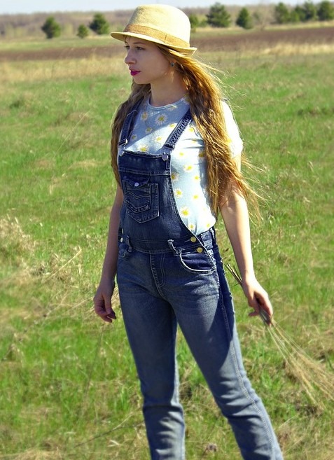 A woman in the farm wearing a denim jumper and a floral T-shirt