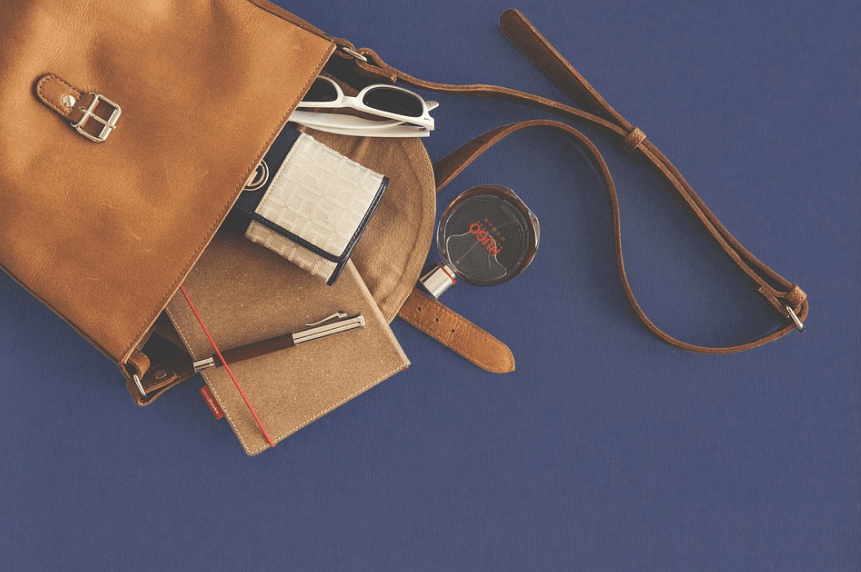 leather handbag, perfume, notebook, pen, sunglasses, wallet