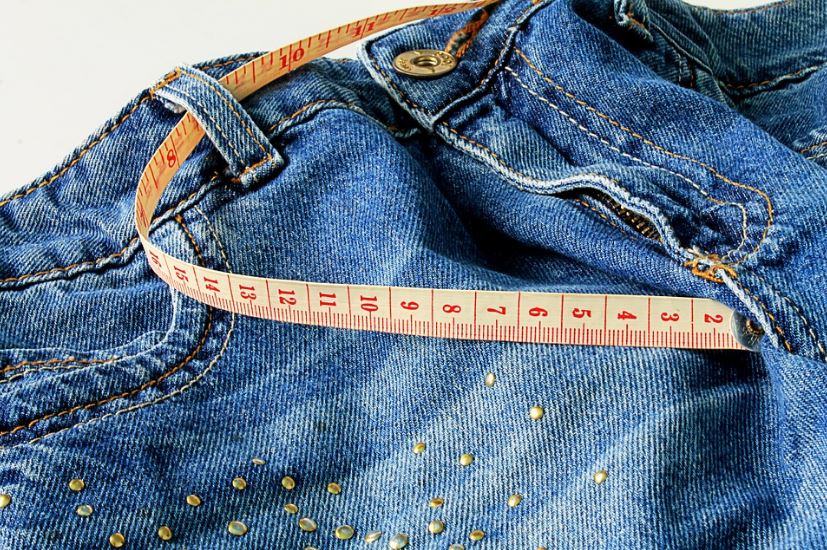 A tape measure on jeans