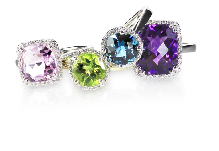 Row of multicolored rainbow diamond halo gemstone rings