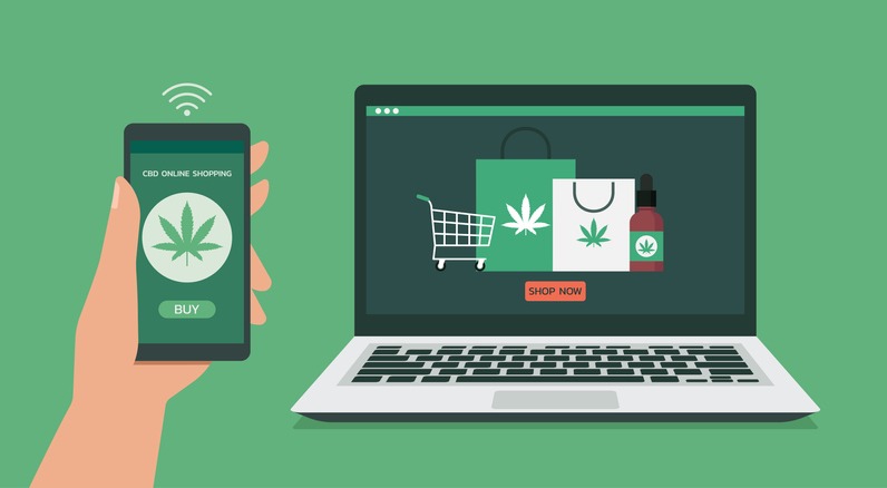 human hand using smartphone connect with laptop order cannabis or cbd product online