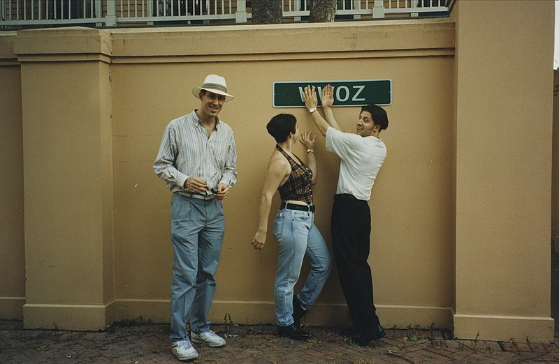 Trio in 1995 wearing neutral-colored tops and relaxed-fit, slim-leg pants and jeans.