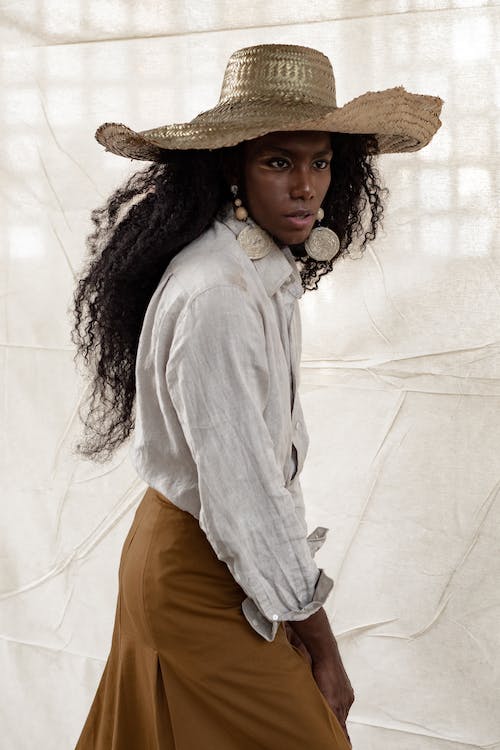 stylish black model in a straw hat