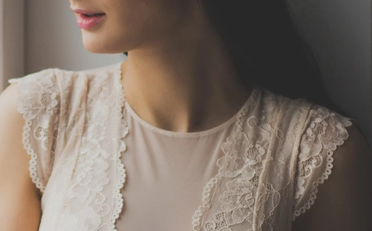 woman in white lace crew neck cap sleeves top
