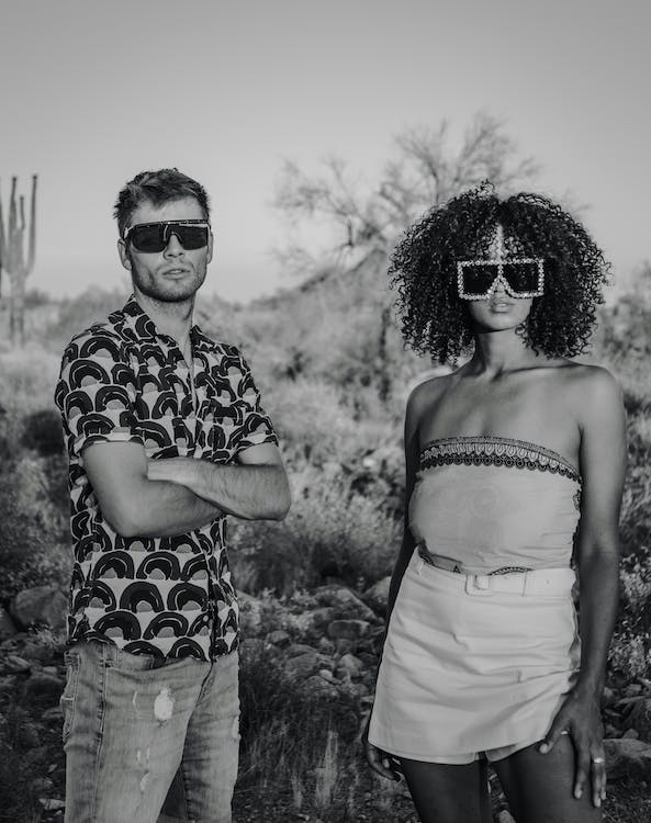 Black and White Photo of Fashion Models on a Semi-Desert  with a man wearing an oxford slim fir shirt