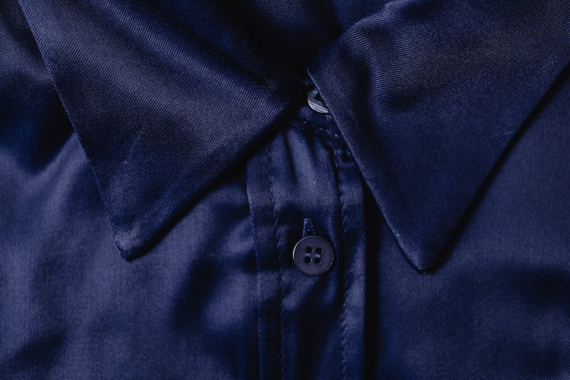 Close-Up Photo of a Blue Textile with a Button