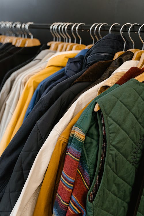 Jackets and Vest Hanging on Clothes Rack 