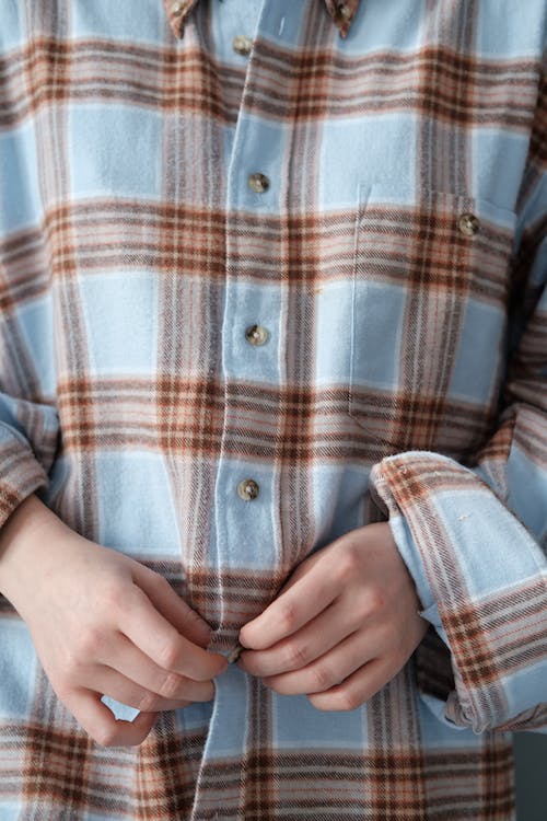 Person in Blue White and Brown Plaid Button Up Shirt 