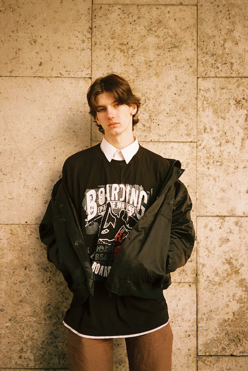 Teenage Boy Wearing Black Blouse with White Collar