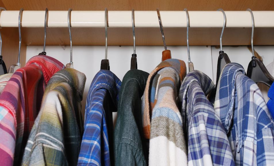A bunch of shirts are hanging on a rack
