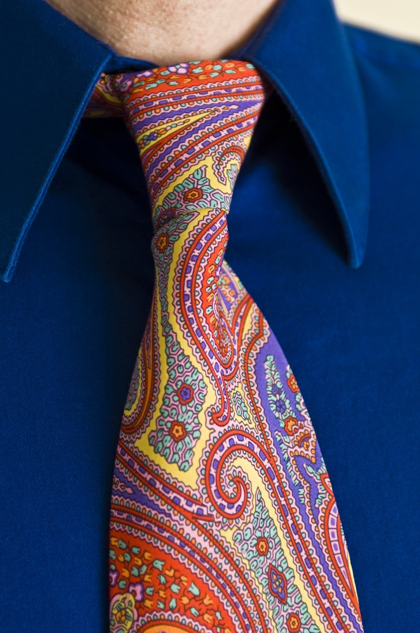 Man wearing brightly colored paisley tie and blue collared shirt
